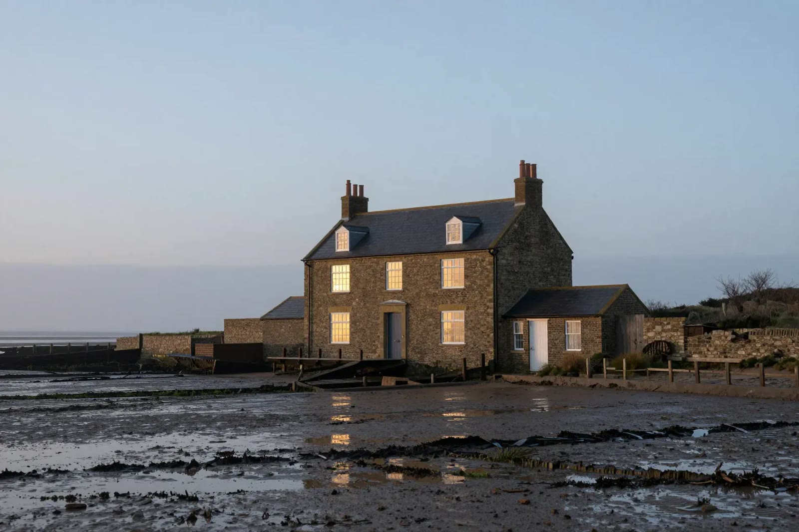 Low Tide House, a flint house on the salt marsh at dawn
